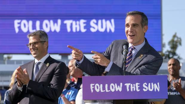 Los Angeles Mayor Eric Garcetti (right) speaks as LA Olympic Committee leader Casey Wasserman applauds during a news conference on Monday in Carson, California. LA braces for unknown in long wait for 2028