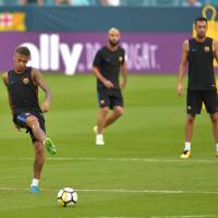 Brazilian star Neymar kicks the ball during a training session with Barcelona last month in Miami. Neymar joined Paris Saint-Germain on a five-year contract on Thursday. Neymar signs with PSG after record transfer deal