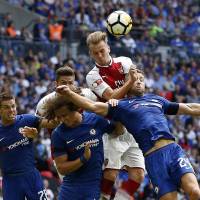Arsenal’s Rob Holding, center, heads the ball during the Gunners’ Community Shield match against Chelsea on Sunday in London. Arsenal wins Community Shield