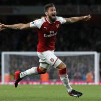 Arsenal’s Olivier Giroud celebrates the decisive goal against Leicester City at Emirates Stadium on Friday in the Premier League season opener. Arsenal edges Leicester in opener