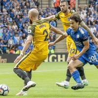 Leicester’s Shinji Okazaki (right) chases Brighton’s Bruno during their match on Saturday in Leicester, England. Okazaki strikes early in victory over Brighton