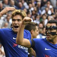 Chelsea’s Marcos Alonso (left) and Pedro celebrate after Alonso’s second goal against Tottenham during their match on Sunday in London. Chelsea adds to Tottenham's misery at Wembley