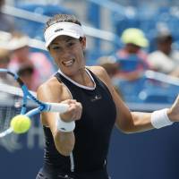 Garbine Muguruza plays a shot from Madison Keys in their third-round match at the Western & Southern Open on Thursday. Muguruza won 6-4, 3-6, 7-6 (7-3). Muguruza rallies to reach quarterfinals