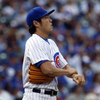 Chicago’s Koji Uehara looks at the scoreboard during Sunday’s game against the Nationals. Cubs' Uehara heads to DL with strained neck