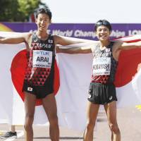 Hirooki Arai (left) and Kai Kobayashi celebrate after the men\'s 50-km race walk at the world championships on Sunday in London. Arai earned the silver medal and Kobayashi took bronze. | KYODO