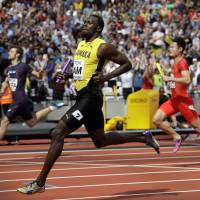Jamaica’s Usain Bolt crosses the finish line in first place in a men’s 4×100-meter relay first-round heat at the IAAF World Athletics Championships on Saturday in London. Bolt guides Jamaica into 100-meter relay final for grand farewell