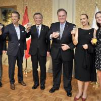 Peruvian Ambassador Harold Forsyth (third from right), Forsyth\'s wife, Maria Veronica Sommer De Forsyth, and his granddaughter, Maria Veronica Forsyth Kelez, raises a toast with (from left) Lower House lawmaker Kenya Akiba, Parliamentary Secretary for Foreign Affairs Hirotaka Ishihara and Jun Matsumoto, minister of state for consumer affairs and food safety, during a reception to mark the anniversary of Peru\'s independence day at the Westin Hotel on July 28. | YOSHIAKI MIURA