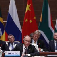Russian President Vladimir Putin attends a plenary session at the BRICS summit in Xiamen, China, on Monday. The five BRICS emerging economies — Brazil, Russia, India, China and South Africa — opened their summit to map out a future course. BRICS countries' leaders meet in China to map path to increase their roles