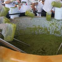 Volunteers from a culinary school mix mashed avocados as they attempt to set a new Guinness World Record for the largest serving of guacamole in Concepcion de Buenos Aires, Jalisco, Mexico, Sunday. Holy guacamole: Mexicans mash up 3 tons of the dip as a NAFTA message