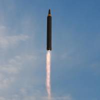 A North Korean Hwasong-12 intermediate-range ballistic missile is launched in this photo released Saturday. U.S.-North Korean tensions prompt H.K.-based airline to delay Guam-Japan flights