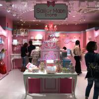 People look at the new Sailor Moon store in Tokyo’s trendy Harajuku district during a media preview Saturday morning. It opened to the public later in the day. First permanent Sailor Moon store opens in Harajuku