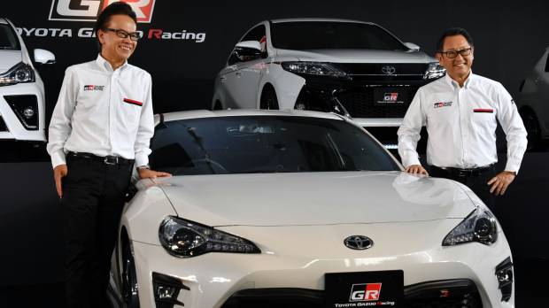Gazoo Racing President Shigeki Tomoyama (left) and Toyota Motor Corp. President Akio Toyoda introduce the carmaker’s new sports car brand, the GR series, Tuesday in Tokyo. Inspired by racing, Toyota roars ahead with GR sports car brand