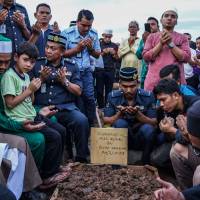 Muslims offer prayers for a victim of the Darul Quran Ittifaqiyah religious school fire during a burial ceremony at Raudhatul Sakinah cemetery in Kuala Lumpur on Friday. Seven youths arrested over deadly fire at religious school in Malaysia