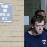 Kenneth James Gleason is escorted by police to a waiting police car in Baton Rouge, Louisiana, Tuesday. Gleason is charged with two counts of first-degree murder and other charges, for three shootings in the Baton Rouge area throughout the past week that resulted in the death of two men. White man accused of murdering two Louisiana blacks had Hitler speech; racial motive not ruled out