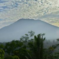 Mount Agung is seen from Karangasem in the eastern part of the Indonesian resort island of Bali on Sunday. Authorities have raised alert levels for Agung after hundreds of small tremors stoked fears it could erupt for the first time in more than 50 years. Tens of thousands flee Bali's rumbling Mount Agung volcano