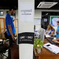 Journalists work at the newsroom of The Cambodia Daily newspaper in Phnom Penh Sunday. English-language The Cambodia Daily shuts with 'dictatorship' parting shot aimed at Hun Sen