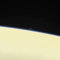 The moon Enceladus and the edge of Saturn are seen from the Cassini spacecraft on its descent toward the planet on Wednesday. The probe disintegrated in the skies above Saturn early Friday after a journey of 20 years. Cassini spacecraft makes fiery final dive into Saturn
