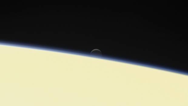 The moon Enceladus and the edge of Saturn are seen from the Cassini spacecraft on its descent toward the planet on Wednesday. The probe disintegrated in the skies above Saturn early Friday after a journey of 20 years. Cassini spacecraft makes fiery final dive into Saturn