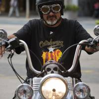 A supporter of Catalonian independence rides his motorcycle in Sabadell, near Barcelona, on Thursday. Spain blocks Catalan independence vote, threatens charges against regional lawmakers