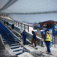 Visitors use a snow escalator at the Wanda Harbin Ice and Snow Park in Harbin, China, on Aug. 22. Chinese skiers cool off at world's largest indoor ski park in Harbin