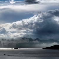 Moisture-laden clouds roll over Hong Kong island early Friday. Parched nations tap cloud seeding