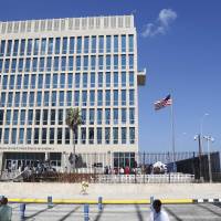A U.S. flag flies at last month the U.S. Embassy in Havana. U.S. investigators are chasing many theories about what’s harming American diplomats in Cuba, including a sonic attack, electromagnetic weapon or flawed spying device. U.S. may again close Cuba embassy after 'health attacks' on diplomats: Tillerson
