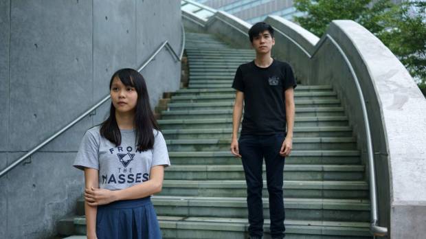 Hong Kong democracy activists Agnes Chow and Lester Shum are seen outside the Hong Kong government headquarters on Aug. 29. After jailing of activists, new faces step up for Hong Kong democracy