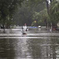 Joey Spalding walks back to his truck down the street where he lives Monday on Tybee Island, Georgia. Spalding just finished repairing his house from 9 inches of water after Hurricane Matthew past the island last year. He said Tropical Storm Irma brought 3 feet of storm surge into his living room Monday. Now a tropical storm, Irma crosses Southeast, leaves three dead in Georgia, one in South Carolina