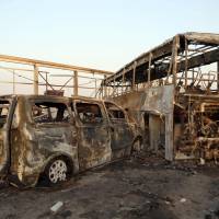 Vehicles are gutted after gunmen and suicide car bombers killed dozens of people in two assaults claimed by Islamic State (IS) group jihadis near the southern Iraqi city of Nasiriyah on Thursday. The attackers struck at midday, opening fire on a restaurant before getting into a car and blowing themselves up at a nearby security checkpoint, officials said. Iranians listed among 74 dead in Iraq attacks claimed by Islamic State targeting Shiites