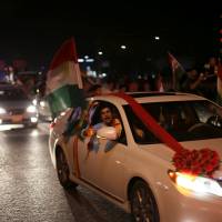 Kurds celebrate to show their support for the independence referendum in Irbil, Iraq, Monday. Iraqi Kurds cast independence vote in defiance of threats and opposition from Ankara, Baghdad, Tehran