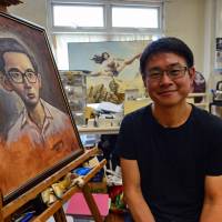 Singapore cartoonist Sonny Liew poses with some of his work at his office on Aug. 3. Award-winning Singapore Sonny Liew cartoonist challenges history with best-seller