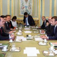 French President Emmanuel Macron (second from right) talks with president of the Venezuelan parliament Julio Borges (left) and vice president of the Venezuelan parliament Freddy Guevara (second from left) during a meeting at the Elysee Palace in Paris Monday. Macron holds crisis talks with Venezuela opposition leaders, draws scorn, aid rejection from Maduro