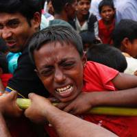A Rohingya refugee boy jostles for aid in Cox’s Bazar, Bangladesh, Wednesday. Macron pulls no punches: Rohingya crisis in Myanmar constitutes 'genocide'