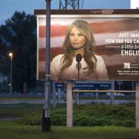 A worker carrying a ladder walks past a billboard depicting U.S. first lady Melania Trump and advertising a language school displayed in Zagreb, Croatia, on Friday. Melania Trump threatens lawsuit over English class billboard