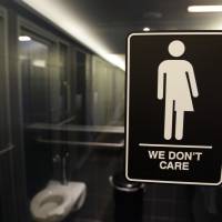 Signage is seen outside a restroom at the 21c Museum Hotel in Durham, North Carolina, last year. The Montana Supreme Court has ordered the attorney general to rewrite ballot language for an initiative that would require people to use public restrooms designated for their gender at birth. The court ruled Tuesday in a challenge from the American Civil Liberties Union of Montana, saying the language didn’t include the initiative’s specific definition of “sex” and was otherwise vague. Court orders Montana attorney general to rewrite transgender bathroom initiative