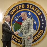 U.S. Defense Secretary Jim Mattis (left) shakes hands with Gen. John Hyten, head of the U.S. Strategic Command, at Offutt Air Force Base in Bellevue, Nebraska, on Thursday. Mattis received classified briefings to help him in his top-to-bottom reassessment of the United States’ nuclear weapons policy. Pentagon reviewing nuclear arsenal; experts say modernization could cost $1 trillion