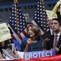 U.S. House Minority Leader Nancy Pelosi tries to talk as protesters demonstrate during a press conference on the DREAM ACT on Monday in San Francisco. Several dozen young immigrants shouted down Pelosi, the top Democrat in the U.S. House, on Monday following her recent conversations with President Donald Trump over the future of a program that grants many of them legal status Young immigrants shout down Democratic leader Nancy Pelosi over Dreamer deal with Trump