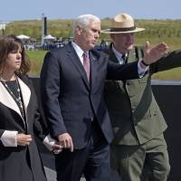 Stephen M. Clark, superintendent of the Flight 93 Memorial, right, shows the flight path of United Flight 93 to Vice President Mike Pence and his wife, Karen, at the Flight 93 National Memorial in Shanksville, Pennsylvania, Monday. Pence at crash site praises Flight 93 passengers who stormed cockpit on 9/11 for possibly saving his life