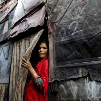 A Rohingya Muslim woman stands by the entrance to her shanty at a camp for refugees in New Delhi Monday. India’s government said Monday it has evidence there are extremists who pose a threat to the country’s security among the Rohingya Muslims who have fled Myanmar and settled in many Indian cities. India says it has evidence that extremists among Rohingya Muslim settlers pose security threat