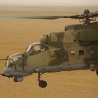 Russian military helicopter flies over a desert in Deir es-Zor province, Syria, in this file photo dated Sept. 15. Russian special forces are helping Syrian government troops fight Islamic State militants in the battle underway in eastern Syria, the defense ministry in Moscow said on Thursday. Russia issues warning to U.S. of special forces in Syria, ready to retaliate if provoked