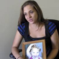 Trista Reynolds holds a photo of her daughter, Ayla Reynolds, during a 2013 interview with the Associated Press in Westbrook, Maine. Trista Reynolds asked in a probate court hearing Thursday in Portland, Maine, that her daughter Ayla be declared dead more than five years after her disappearance, so she can file a wrongful death lawsuit against the toddler’s father. Maine judge to weigh whether to declare toddler who vanished from father's home in 2011 dead