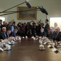 President Donald Trump (right) speaks during a meeting with Malaysian Prime Minister Najib Razak (second from left) in the Cabinet Room of the White House Tuesday in Washington. Trump meeting with Malaysian leader under scrutiny after massive corruption scandal gets no mention