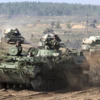 Belarusian army vehicles drive preparing for war games Monday at an undisclosed location in Belarus. Russia and Belarus are holding a massive war games, Zapad 2017, that started on Thursday near the borders of Poland, Estonia, Latvia and Lithuania. Russia-Belarus major war games rattle Europe, NATO, seen as 'open preparation' to fight the West