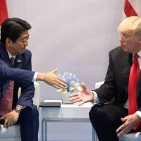 Prime Minister Shinzo Abe shakes hands with U.S. President Donald Trump during a bilateral meeting on the sidelines of the Group of 20 Summit in Hamburg, Germany, in July. Abe weighed meeting with Kim in Pyongyang to lift sagging approval ratings
