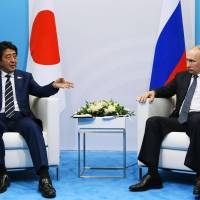 Prime Minister Shinzo Abe meets with Russian President Vladimir Putin in Hamburg in July. Abe and Putin to hold summit Thursday in Vladivostok