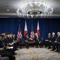 Prime Minister Shinzo Abe and U.S. President Donald Trump (center, right) start their meeting at the Palace Hotel during the 72nd United Nations General Assembly Thursday in New York City. Abe and Trump to call on nations to increase pressure on North Korea and strictly enforce U.N. sanctions