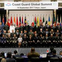 Heads of coast guard organizations from over 30 nations attend a family photo session during the Coast Guard Global Summit, jointly hosted by the Japan Coast Guard and Tokyo-based Nippon Foundation, in Tokyo on Thursday. Coast guard leaders from 34 nations gather in Tokyo for inaugural summit