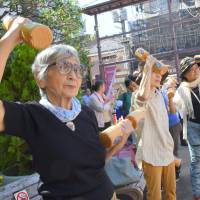 Seniors exercise Monday during a health promotion event for Respect for the Aged Day at Koganji Temple in Tokyo’s Sugamo neighborhood. The street near the temple is known as a popular shopping area for seniors. Number of people in Japan aged 90 and above tops 2 million for first time