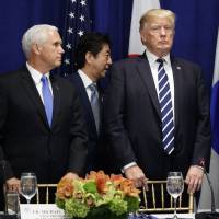 Prime Minister Shinzo Abe walks to his seat at a luncheon attended by President Donald Trump and South Korean President Moon Jae-in at the Palace Hotel during the United Nations General Assembly in New York on Thursday, as Vice President Mike Pence and Secretary of State Rex Tillerson stand by. Analysis: Abe's aggressive approach to North Korea succeeds at the U.N., for now