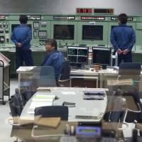 Tokyo Electric Power Company Holdings Inc. employees take part in a drill in the simulator of the central control room for a reactor inside the seismic isolation building at the company’s Kashiwazaki-Kariwa nuclear power station in Kashiwazaki, Niigata Prefecture, in February 2015. Two reactors at Tepco's giant Niigata plant close to being restarted